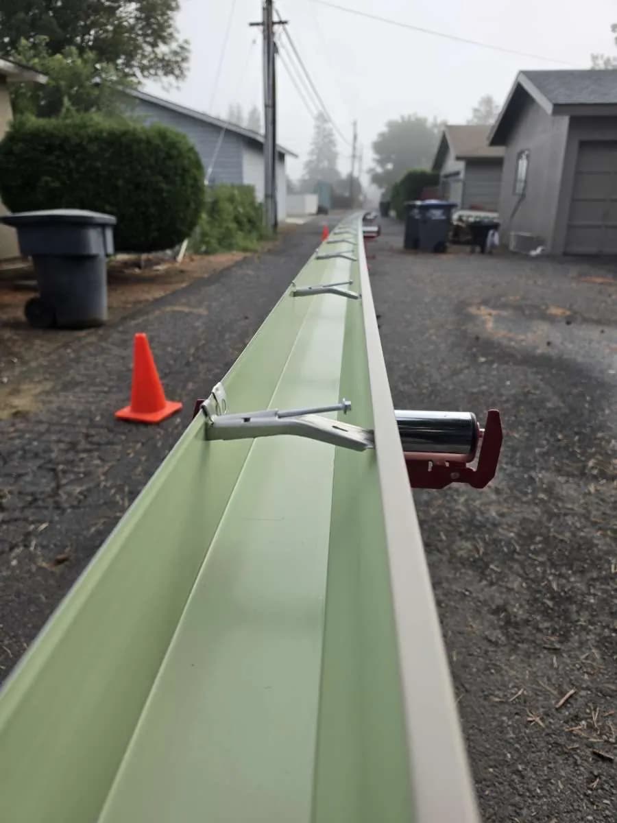 Seamless gutter freshly formed on-site in a residential driveway