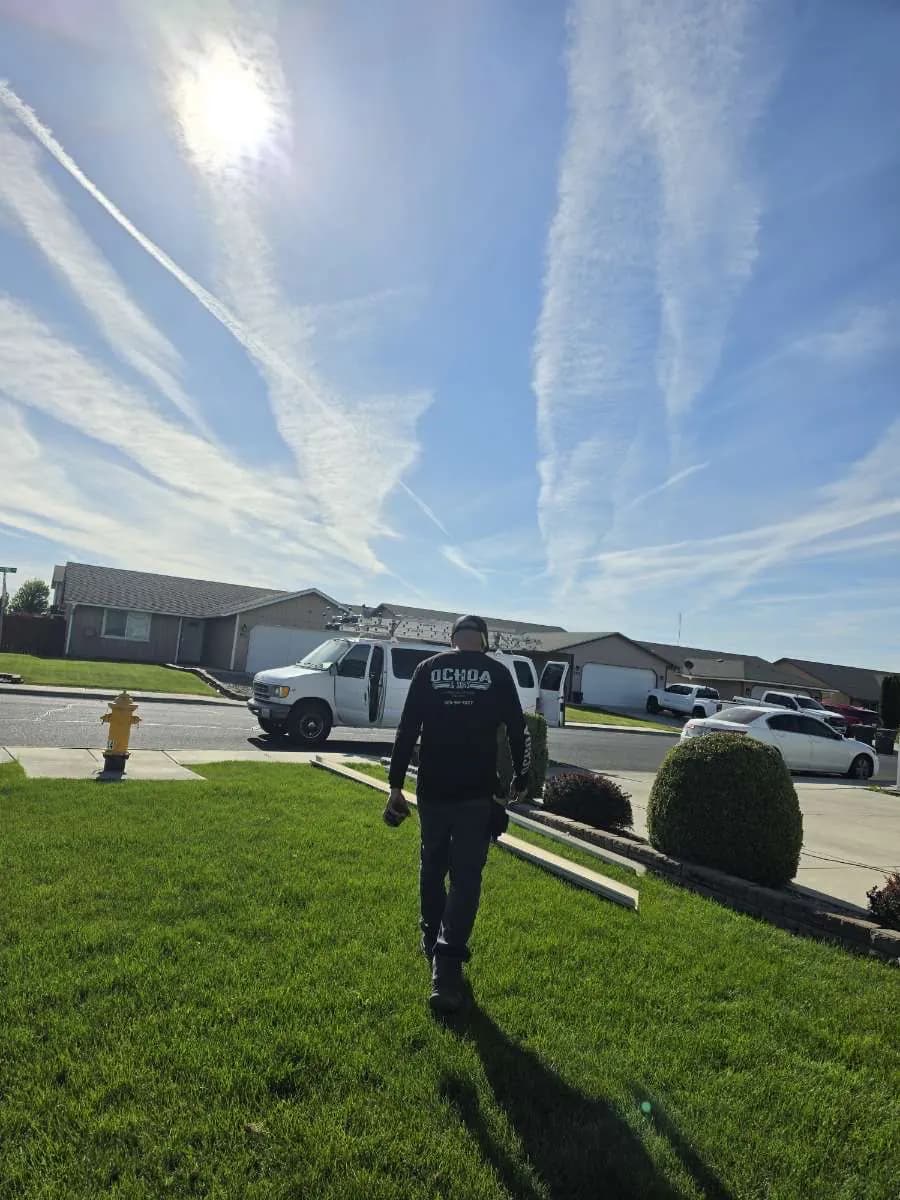 Crew member carrying a finished seamless gutter to the house for a clean installation