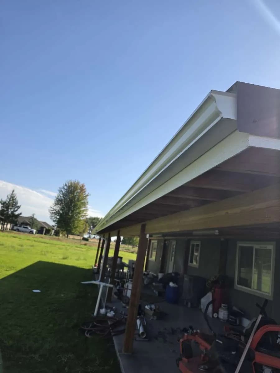 Gutter replacement: new seamless gutter installed along a covered porch roofline
